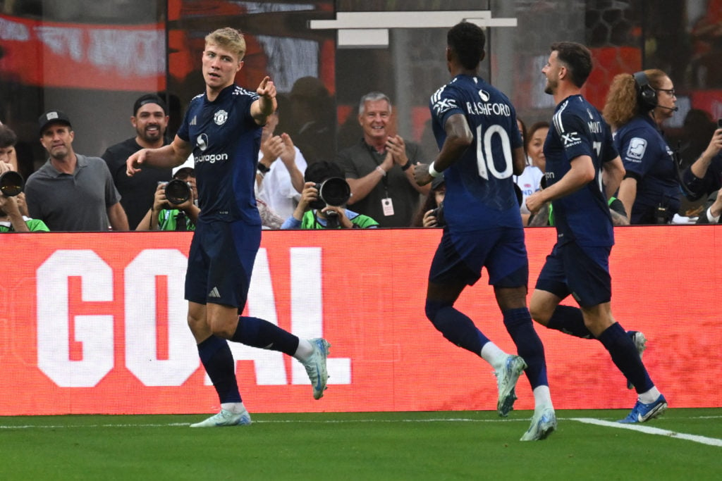 The Danish striker no.  Manchester United's 09 Rasmus Hojlund (L) reacts after scoring a goal during the pre-season friendly soccer match between Ma...