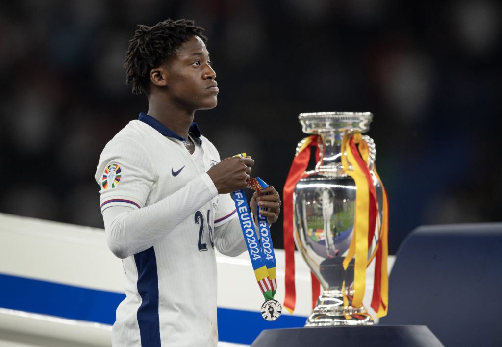 Kobbie Mainoo of England walks past the trophy with his runners up medal after the UEFA EURO 2024 final match between Spain and England at Olympias...