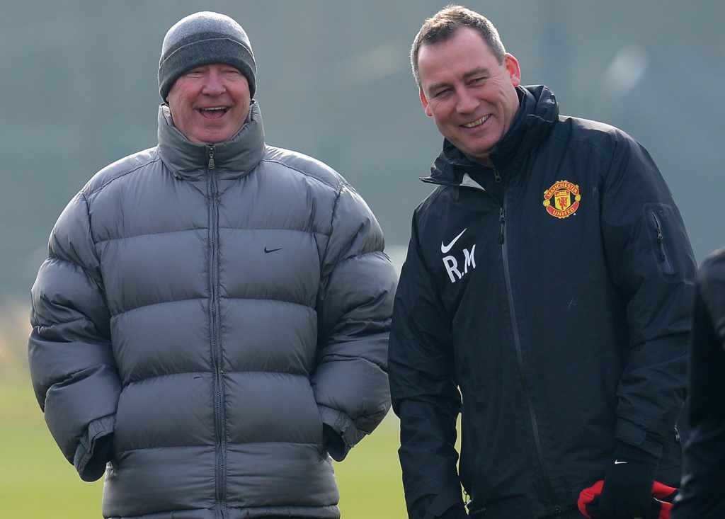 Manchester United manager Alex Ferguson (L) laughs with first team coach Rene Meulensteen during a training session at the Carrington training comp...