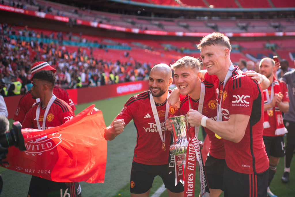 Scott McTominay, Rasmus Hojlund and Sofyan Amrabat of Manchester United celebrate with the Emirates FA Cup trophy after winning the Emirates FA Cup...