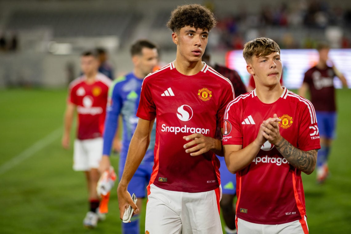 Ethan Wheatley and Sam Mather of Manchester United applaud the fans after a pre-season friendly match between Manchester United v Real Betis at Sna...