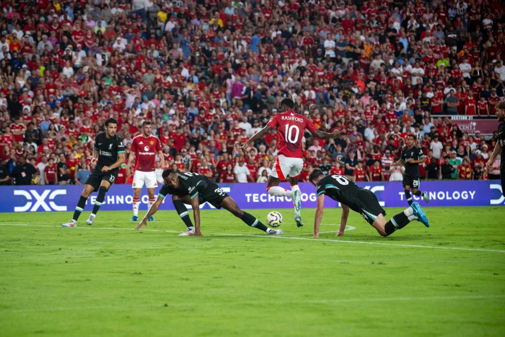 Marcus Rashford of Manchester United is challenged for the ball by Ryan Gravenberch of Liverpool FC during a pre season friendly match between Manc...