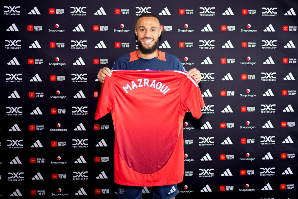 (EXCLUSIVE COVERAGE) Noussair Mazraoui of Manchester United poses after signing for the club at Carrington Training Ground on August 13, 2024 in Ma...