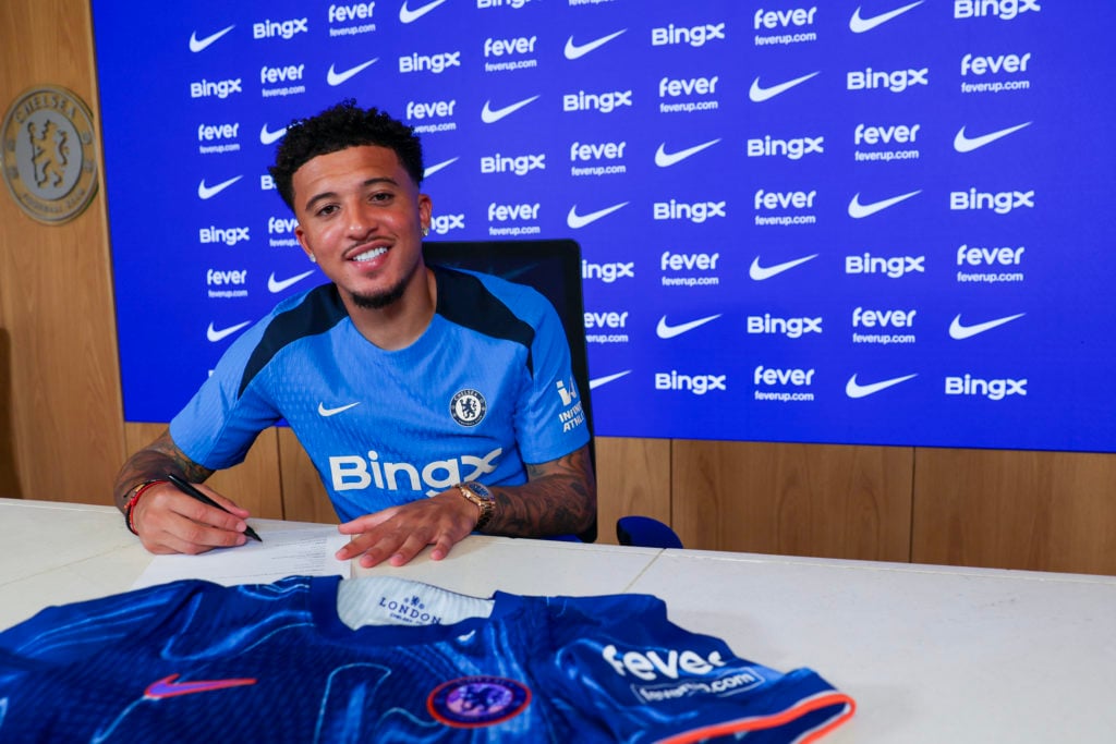 Jadon Sancho poses for pictures as he signs for Chelsea Football Club at Chelsea Training Ground on August 30, 2024 in Cobham, England.