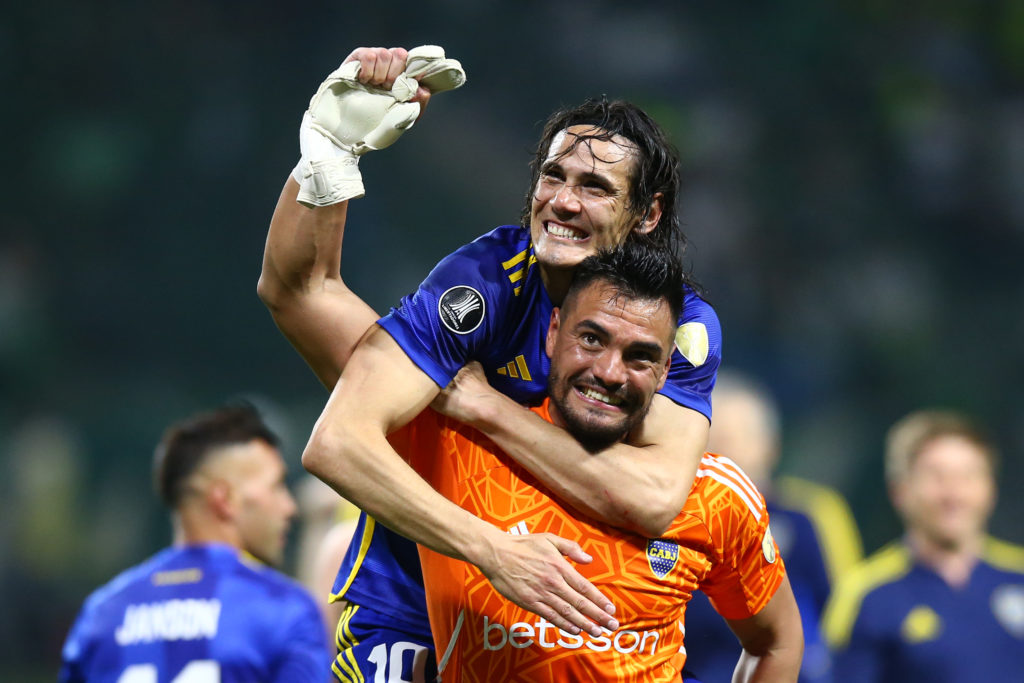 Edinson Cavani of Boca Juniors celebrates with teammate Sergio Romero after winning in the penalty shoot out and advancing to the tournament's fina...