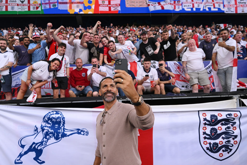 Rio Ferdinand, former England player, takes a selfie photograph with fans prior to the UEFA EURO 2024 semi-final match between Netherlands and Engl...