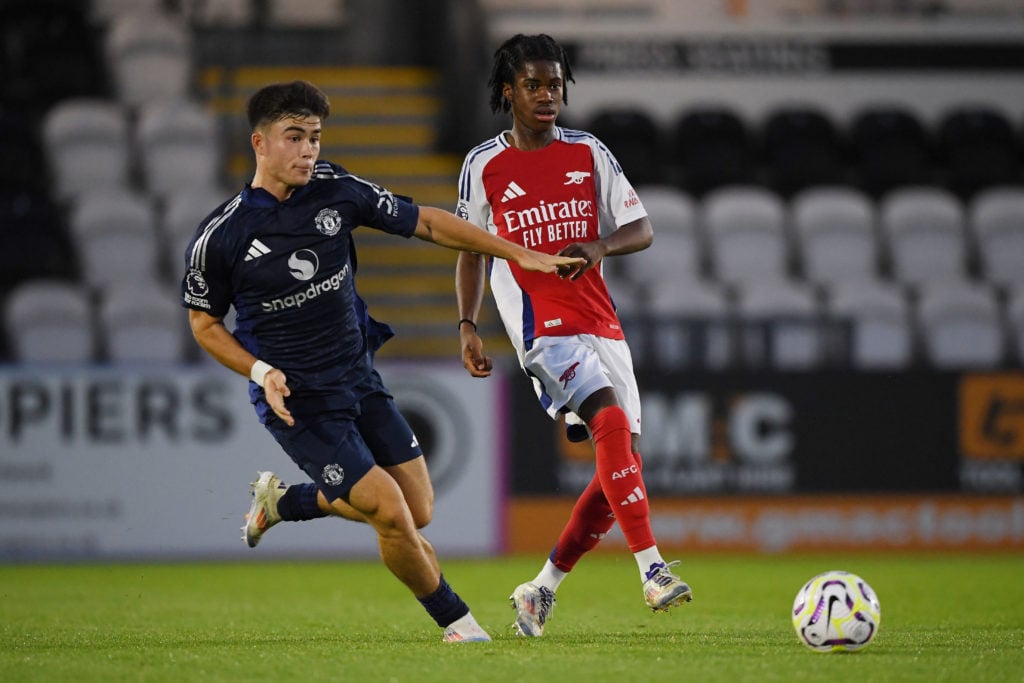 Josh Nichols of Arsenal passes the ball under pressure from Harry Amass of Manchester United during the Premier League 2 match between Arsenal U21 ...