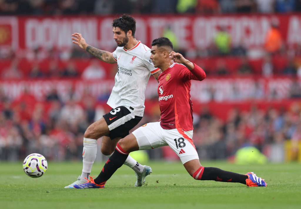 Casemiro of Manchester United tackles Dominik Szoboszklai of Liverpool during the Premier League match between Manchester United FC and Liverpool...