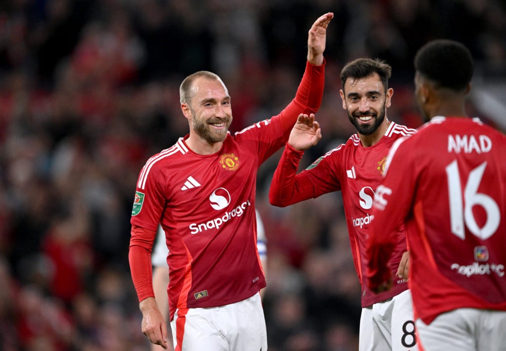 Christian Eriksen of Manchester United celebrates his team's sixth goal with teammates Bruno Fernandes and mun16as during the Carabao Cup T...