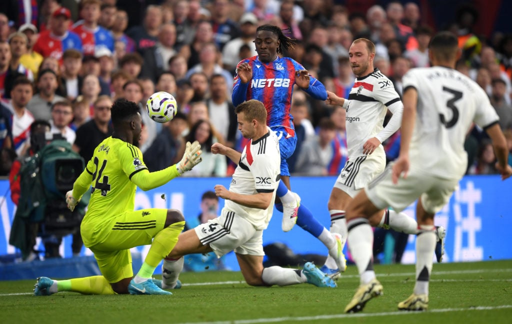 Eberechi Eze of Crystal Palace shoots under pressure from Matthijs de Ligt of Manchester United, which is saved by Andre Onana of Manchester United...