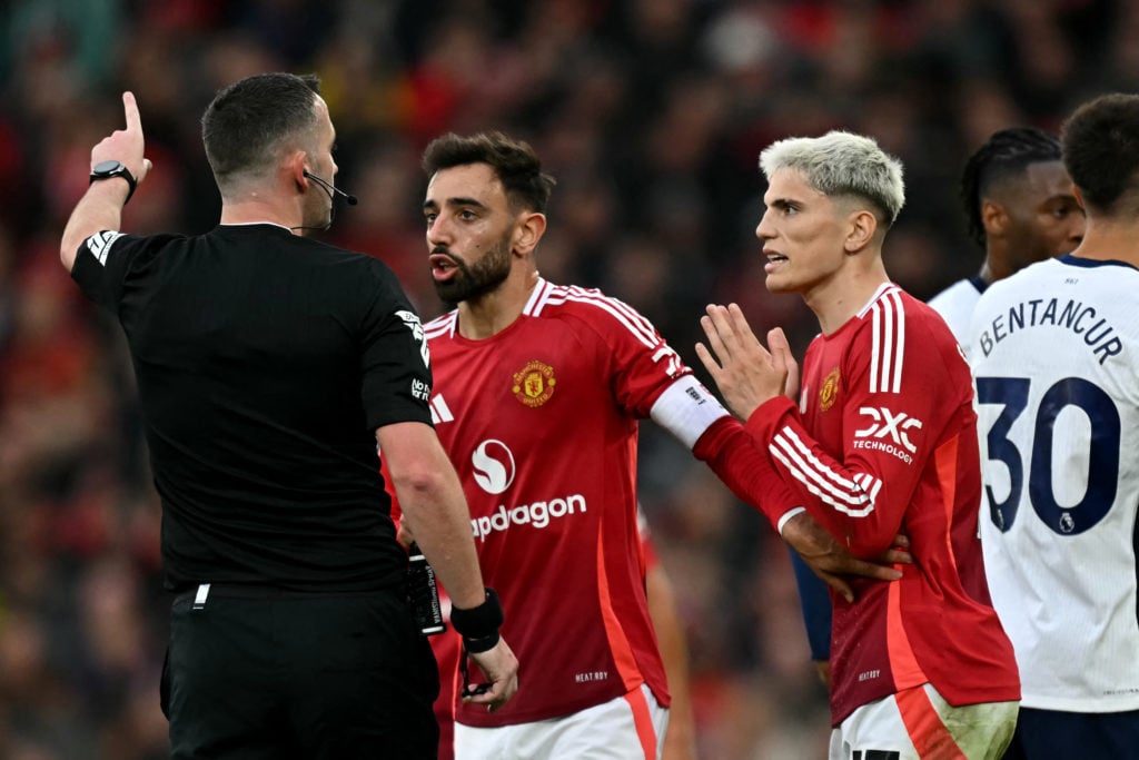 Manchester United's Portuguese midfielder #08 Bruno Fernandes (C) talks to English referee Chris Kavanagh after being sent off during the English P...