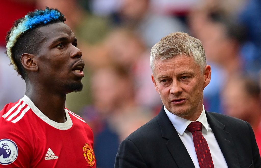 Manchester United's Norwegian manager Ole Gunnar Solskjaer (R) talks with Manchester United's French midfielder Paul Pogba as they leave the pitch ...