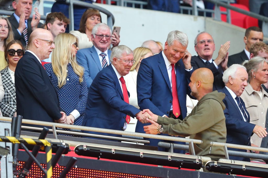 Josep 'Pep' Guardiola, manager of Manchester City, is greeted by Sir Alex Ferguson, former manager of Manchester United, after the FA Cup final ma...