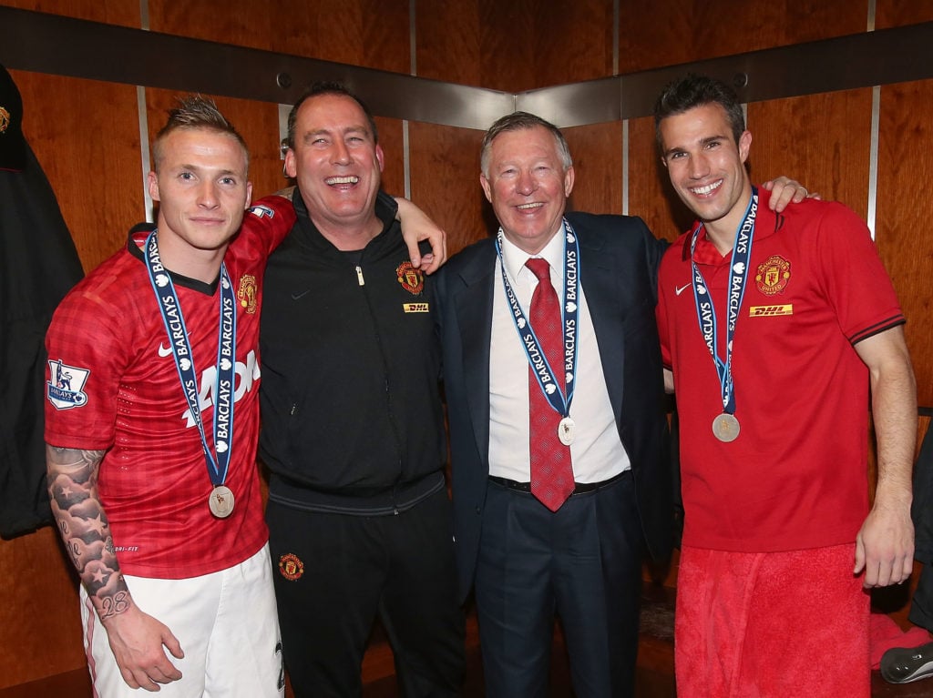 Alexander Buttner, First Team Coach Rene Meulensteen, Manager Sir Alex Ferguson and Robin van Persie of Manchester United celebrate in the dressin...