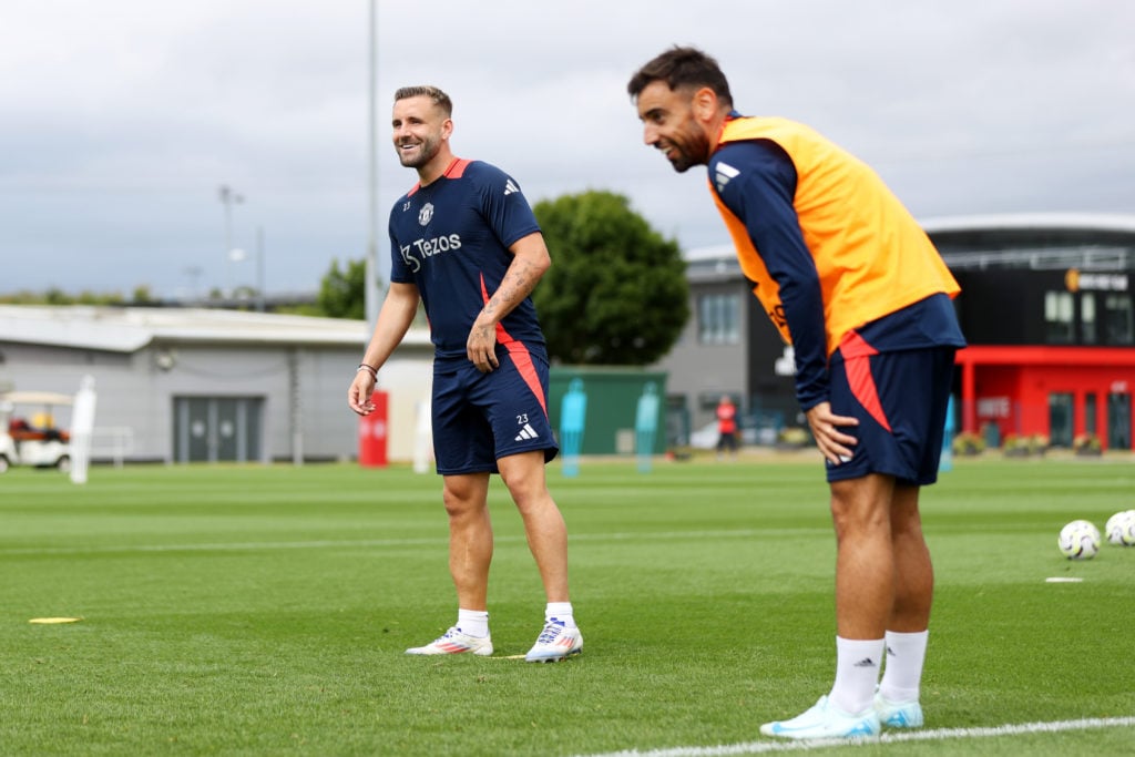 Luke Shaw and Bruno Fernandes of Manchester United in action during a first team training session at Carrington Training Ground on August 05, 2024 ...