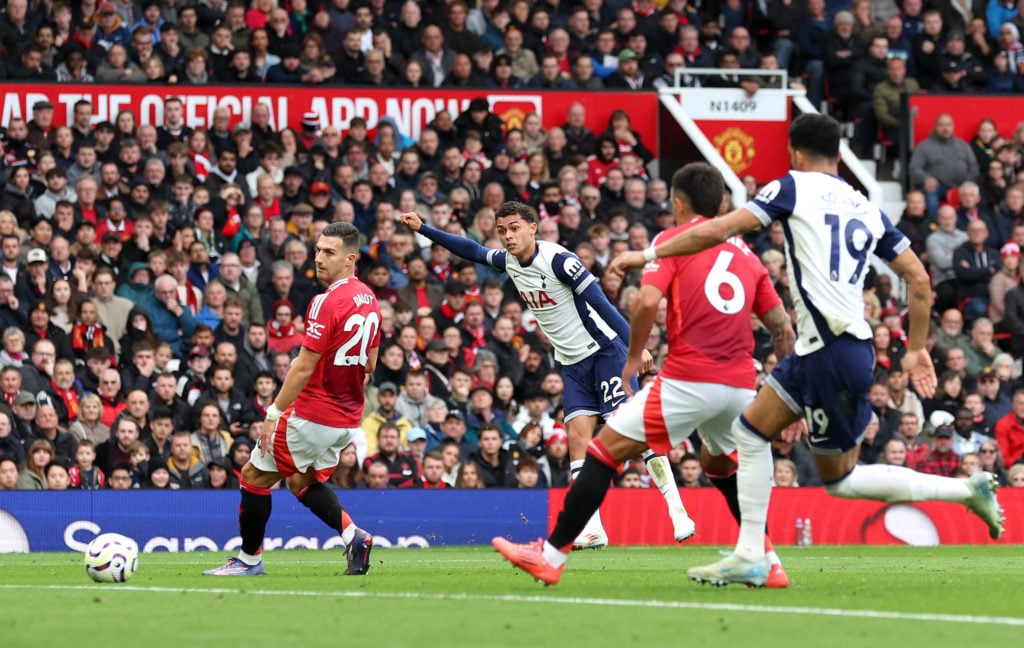 Brennan Johnson of Tottenham Hotspur shoots, under pressure from Diogo Dalot and Lisandro Martinez of Manchester United during the Premier League m...