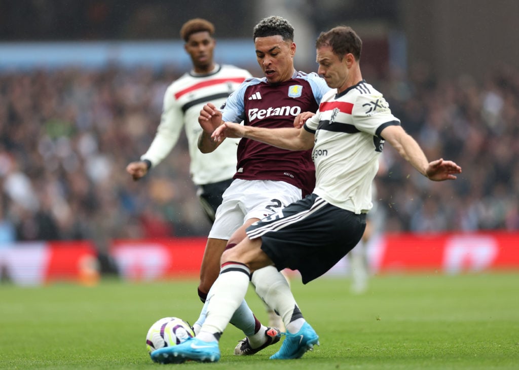 Morgan Rogers of Aston Villa is challenged by Jonny Evans of Manchester United during the Premier League match between Aston Villa FC and Mancheste...