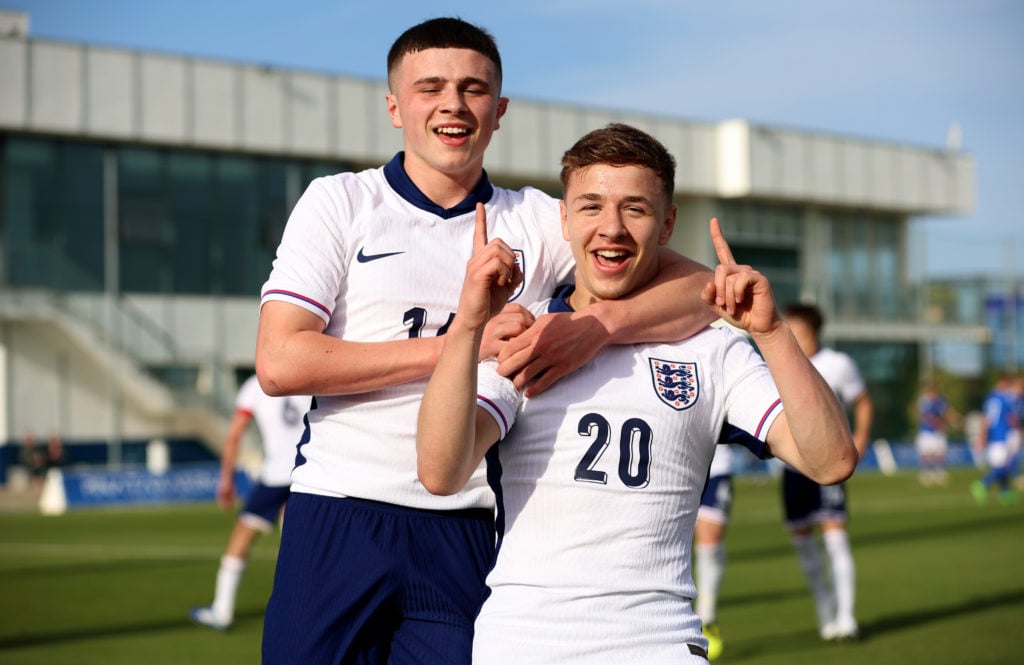 England's Amir Ibragimov celebrates with teammate Jake Evans after scoring his team's second goal during the match between England and...