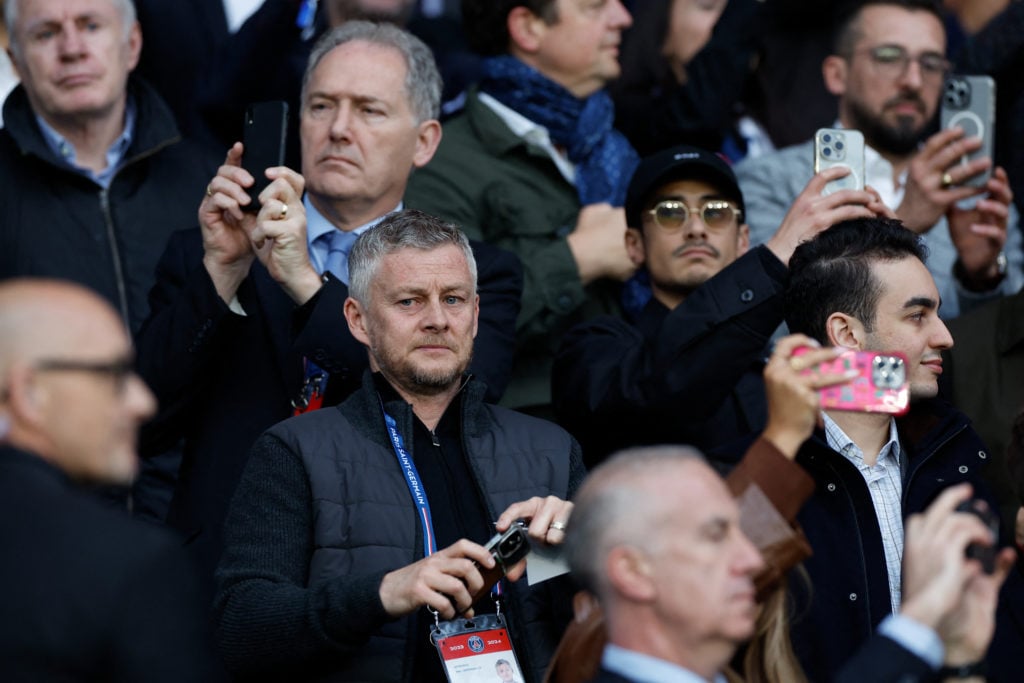 Former Manchester United forward Norway's Ole Gunner Solskjaer (C) looks on from the stands during the UEFA Champions League semi-final second leg ...