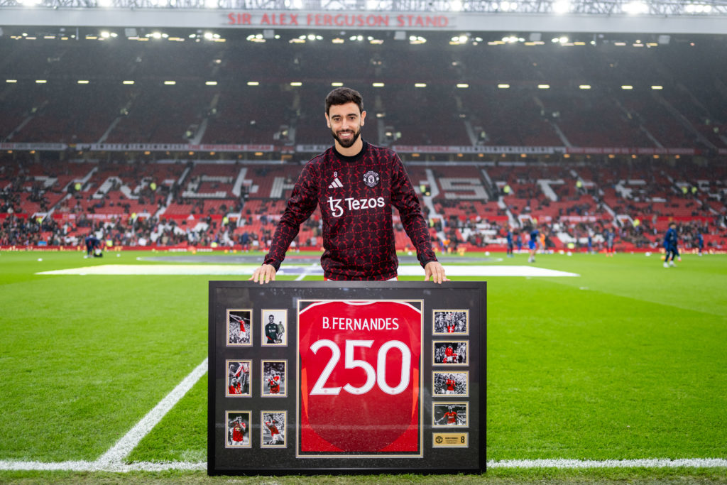 Manchester United's Bruno Fernandes is presented with a shirt to mark his 250th appearance for the club ahead of the Premier League match between ...