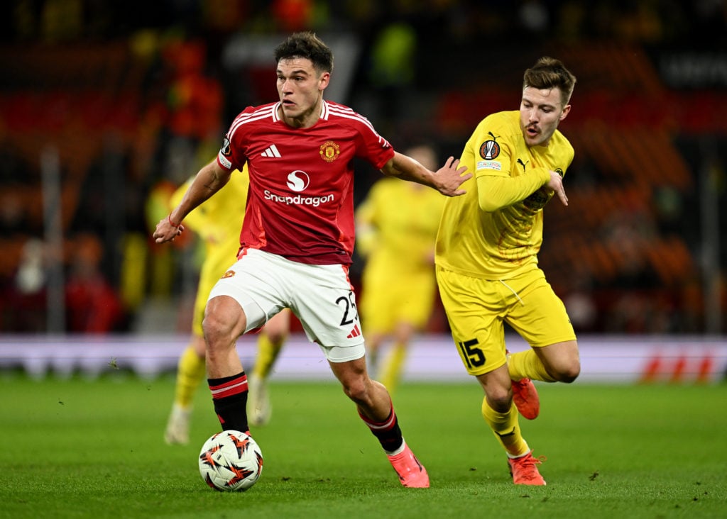 Manuel Ugarte of Manchester United runs with the ball whilst under pressure from Fredrik Andre Bjorkan of FK Bodo/Glimt during the UEFA Europa Leag...