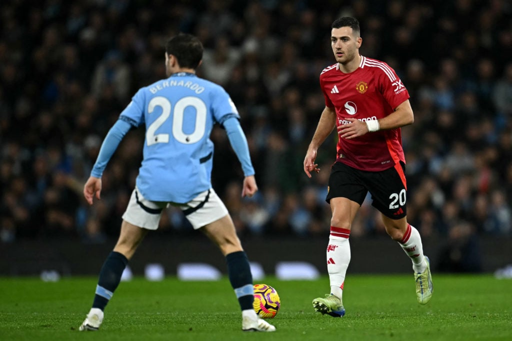 Manchester United's Portuguese defender #20 Diogo Dalot runs with the ball during the English Premier League football match between Manchester City...