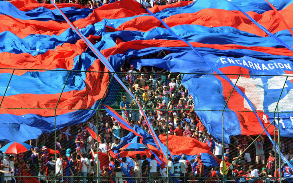 Supporters of Cerro Porteno cheer during