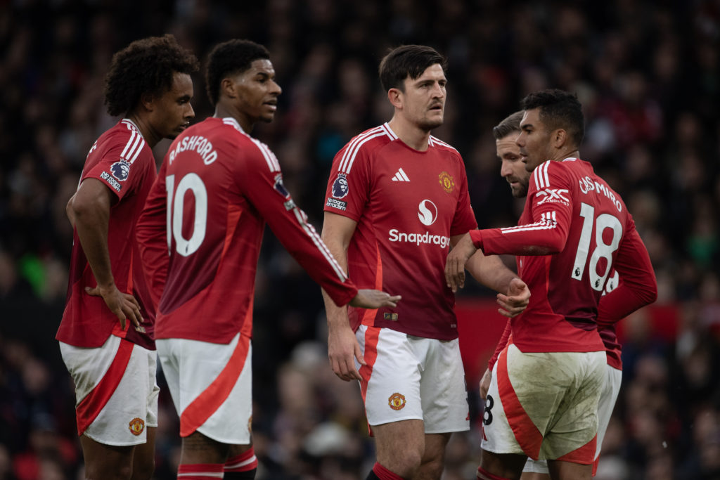 Harry Maguire of Manchester United interacts with team mates Joshua Zirkzee, Marcus Rashford, Casemiro and Mason Mount