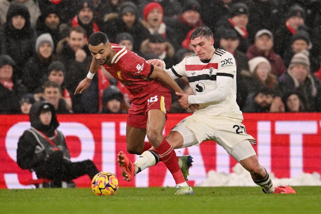 (THE SUN OUT, THE SUN ON SUNDAY OUT) Cody Gakpo of Liverpool is challenged by Manuel Ugarte of Manchester United during the Premier League match be...