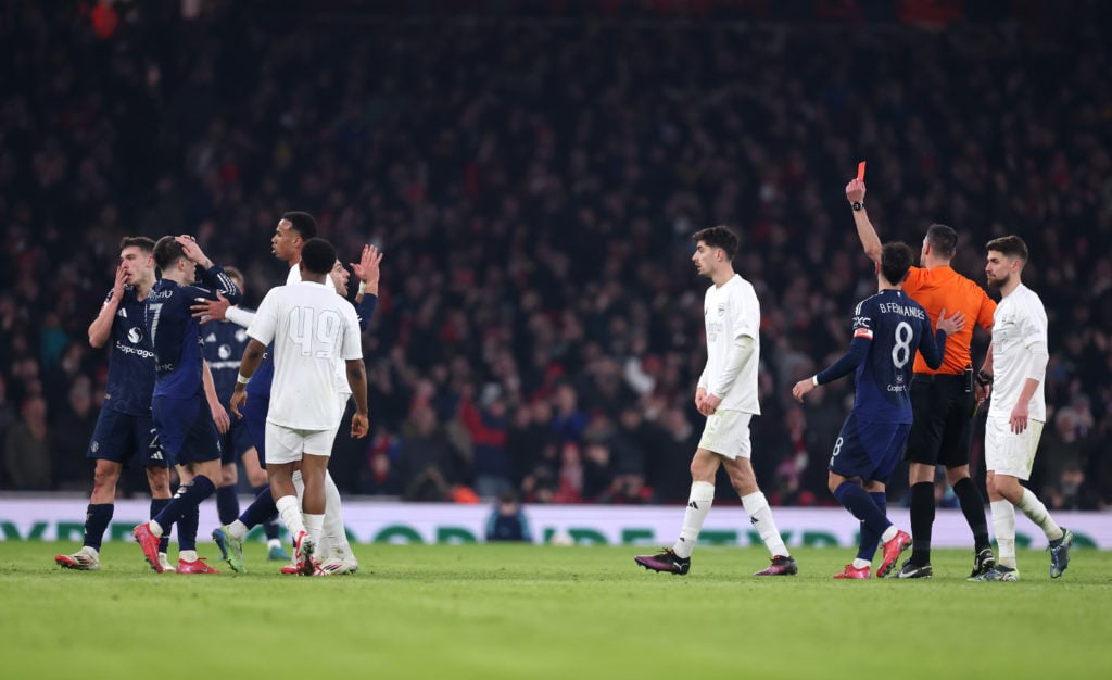 Diogo Dalot of Manchester United receives a red card from referee Andrew Madley during the Emirates FA Cup Third Round match between Arsenal and Ma...