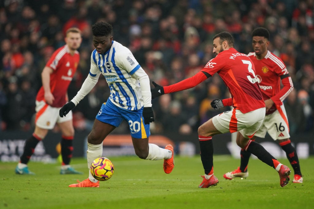 Brighton's Cameroonian midfielder #20 Carlos Baleba (L) fights for the ball Manchester United's Moroccan defender #03 Noussair Mazraoui during the ...