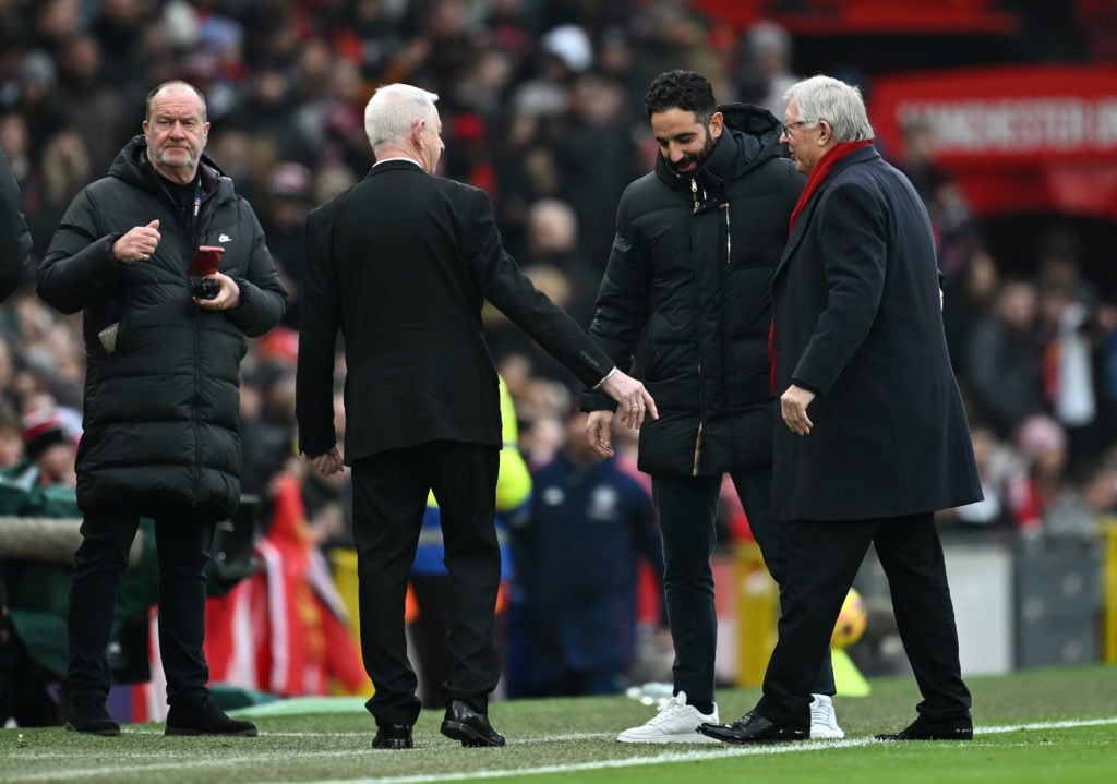 Ruben Amorim, Manager of Manchester United, interacts with Sir Alex Ferguson, former manager of Manchester United prior to the Premier League match...