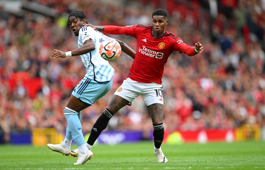 Manchester United player Marcus Rashford is challenged by Forest player Anthony Elanga during the Premier League match between Manchester United an...