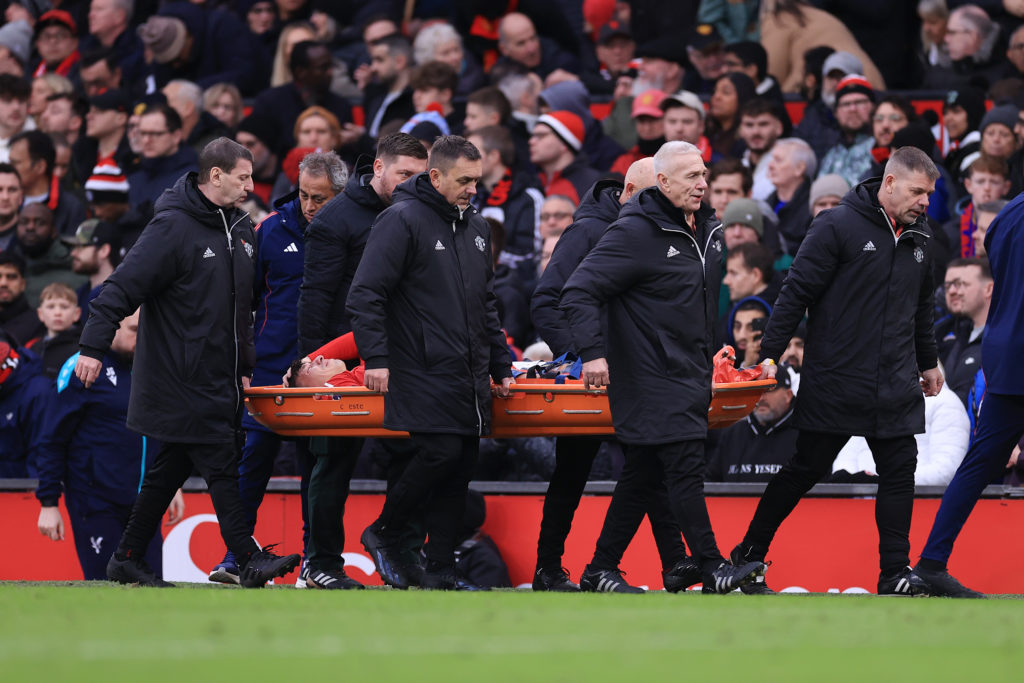 Lisandro Martinez of Manchester United is stretchered off the pitch with an injury during the Premier League match between Manchester United FC and...