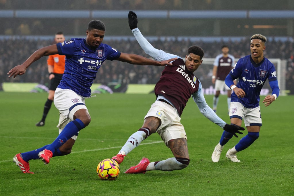 Aston Villa's English striker #09 Marcus Rashford (C) fights for the ball with Ipswich Town's English defender #18 Ben Johnson during the English P...