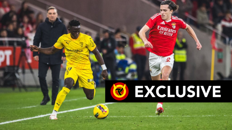 Roger Fernandes in action dribbling with the ball against Benfica's Alvaro Fernandes. Overlaid, the UIF Exclusive banner.
