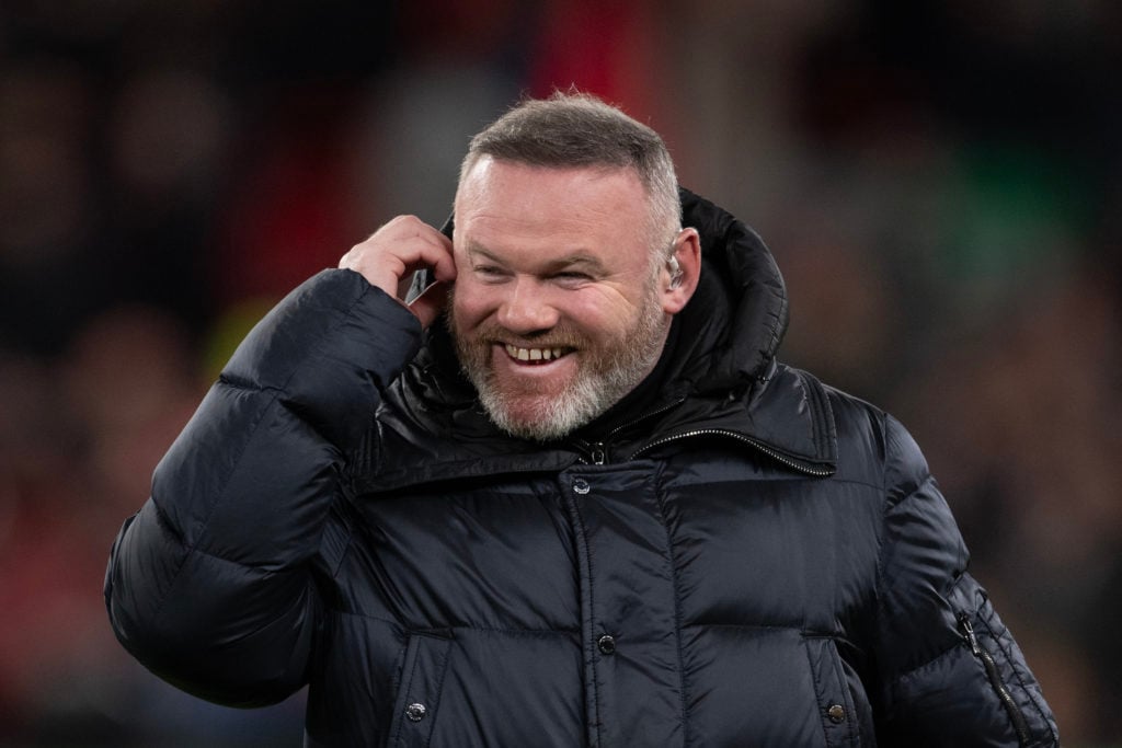 Manchester United and England legend Wayne Rooney is seen laughing prior to the Champions League match between Liverpool and Paris Saint-Germain at Anfield in 2025 in Liverpool, England.