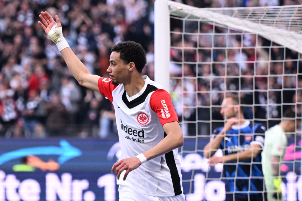 Hugo Ekitike celebrates scoring for Frankfurt with arm in the air.