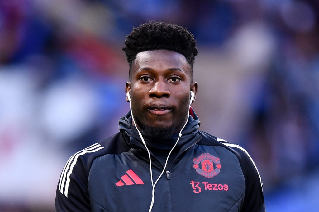 Andre Onana with earphones in while wearing Manchester United training hoodie.