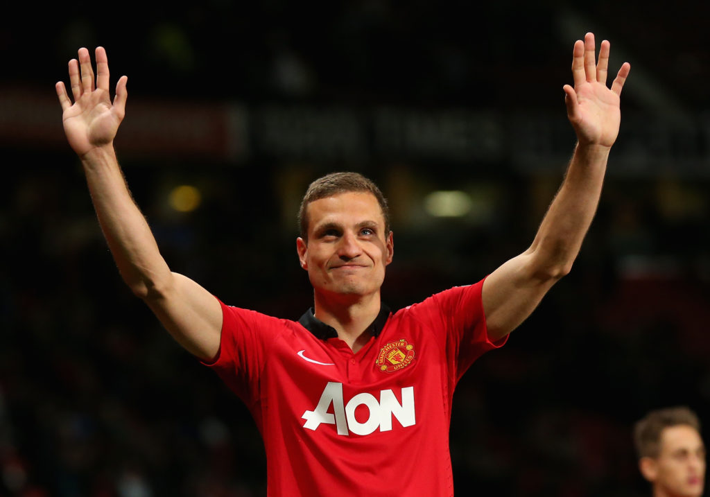 Nemanja Vidic holds arms up to thank Manchester United fans.
