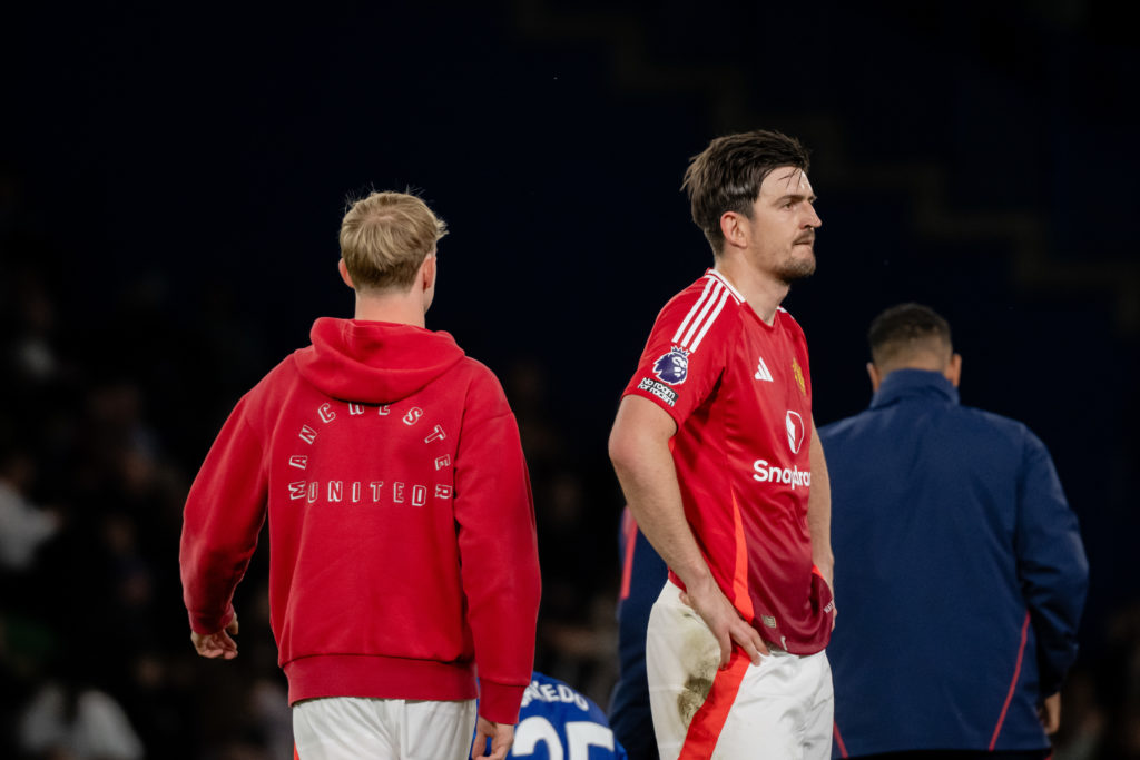 Harry Maguire stands with hands on his hips after Manchester United vs Chelsea, facing away from camera.