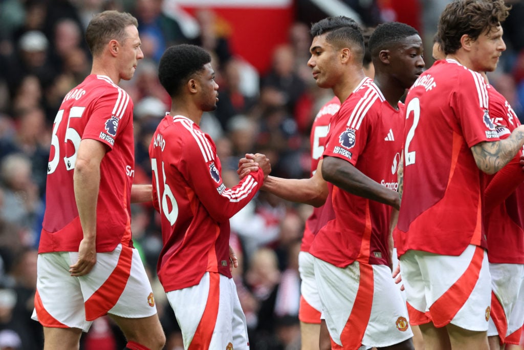 Manchester United's Ivorian forward Amad Diallo celebrates with his teammates after scoring the opening goal during the English Premier League football match between Manchester United and Aston Villa at Old Trafford in Manchester, north west England, on May 25, 2025.