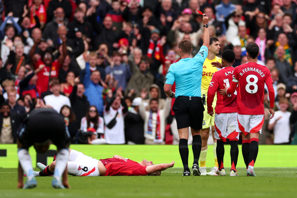 Emiliano Martinez of Aston Villa reacts after being shown a red card by Referee Thomas Bramall for a foul on Rasmus Hojlund of Manchester United during the Premier League match between Manchester United FC and Aston Villa FC at Old Trafford on May 25, 2025