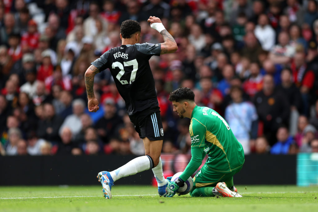 Morgan Rogers of Aston Villa challenges Altay Bayindir of Manchester United before scoring a goal, which was later ruled out by VAR during the Premier League match between Manchester United FC and Aston Villa FC at Old Trafford on May 25, 2025 in Manchester, England.