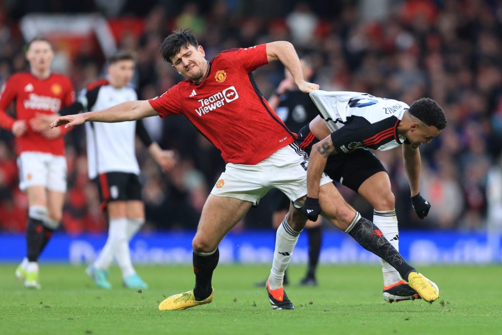 Manchester United defender Harry Maguire battles Fulham striker Rodrigo Muniz.