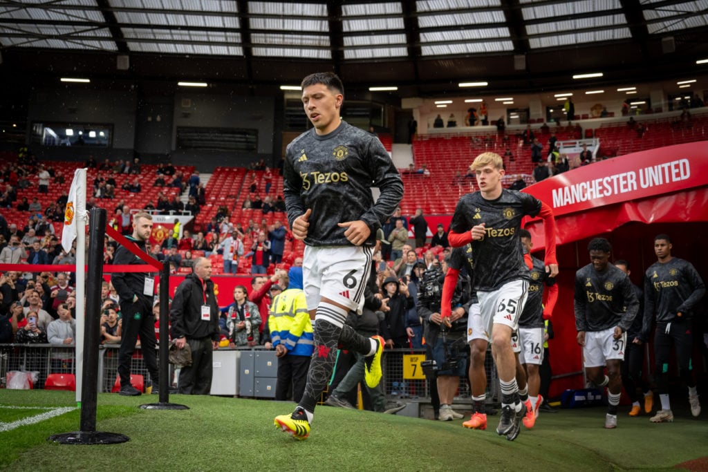Lisandro Martinez and Toby Collyer step onto the pitch to warm up before Manchester United's Premier League match against Newcastle United.