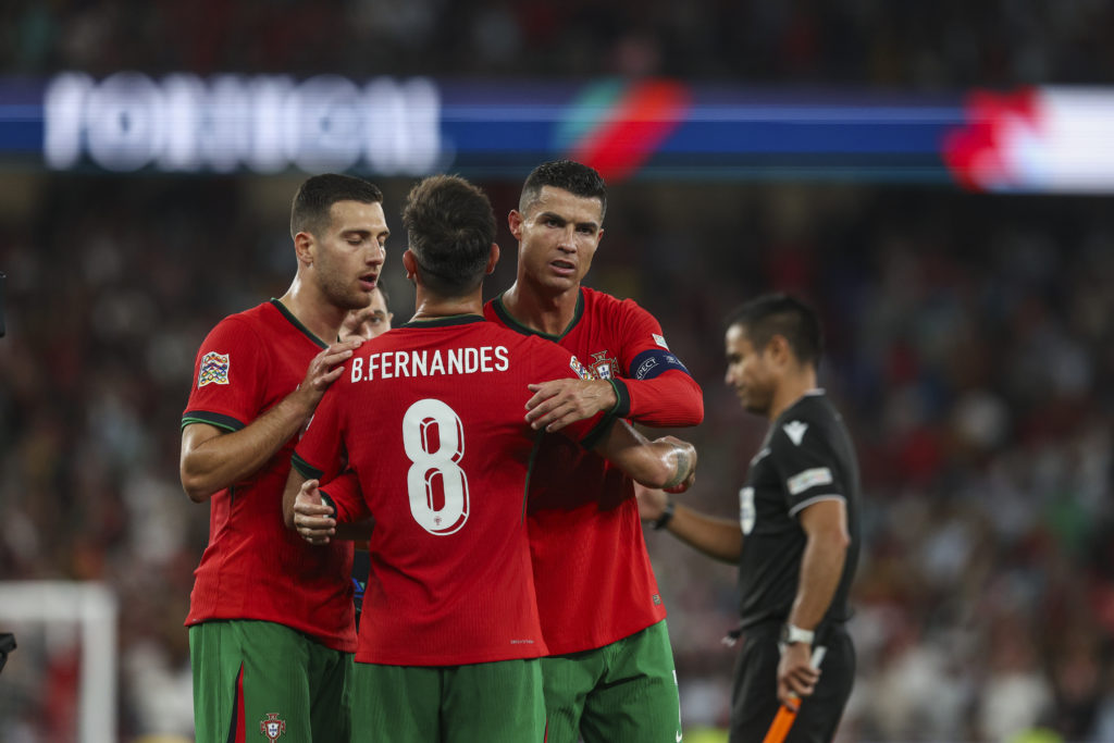Cristiano Ronaldo of Portugal celebrates winning the match with Bruno Fernandes of Portugal and Diogo Dalot of Portugal during the UEFA Nations League match between Portugal and Scotland.