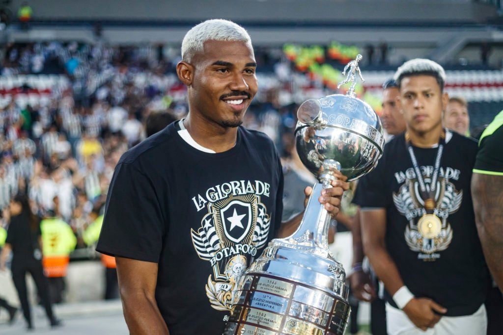 Botafogo defender Cuiabano celebrates with the Copa Libertadores trophy after defeating Atletico Mineiro.