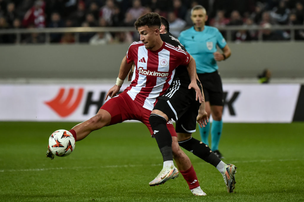 Charalampos Kostoulas of Olympiacos FC is challenged by Marko Jankovi of Qarabag FK during the UEFA Europa League, Jan 30, 2025