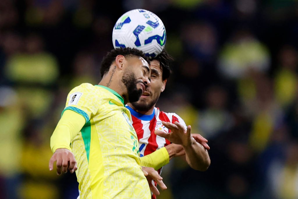 Matheus Cunha and Paraguay defender Junior Alonso fight for the ball during the 2026 FIFA World Cup South American qualifying football match between Brazil and Paraguay at the Neo Quimica Arena in Sao Paulo, Brazil, on June 10, 2025.